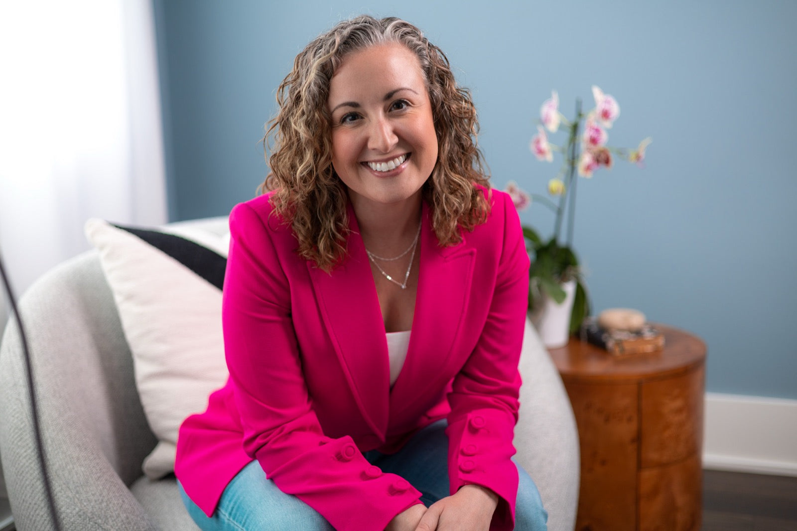 Coach Andrea Burke, seated in a light-filled room