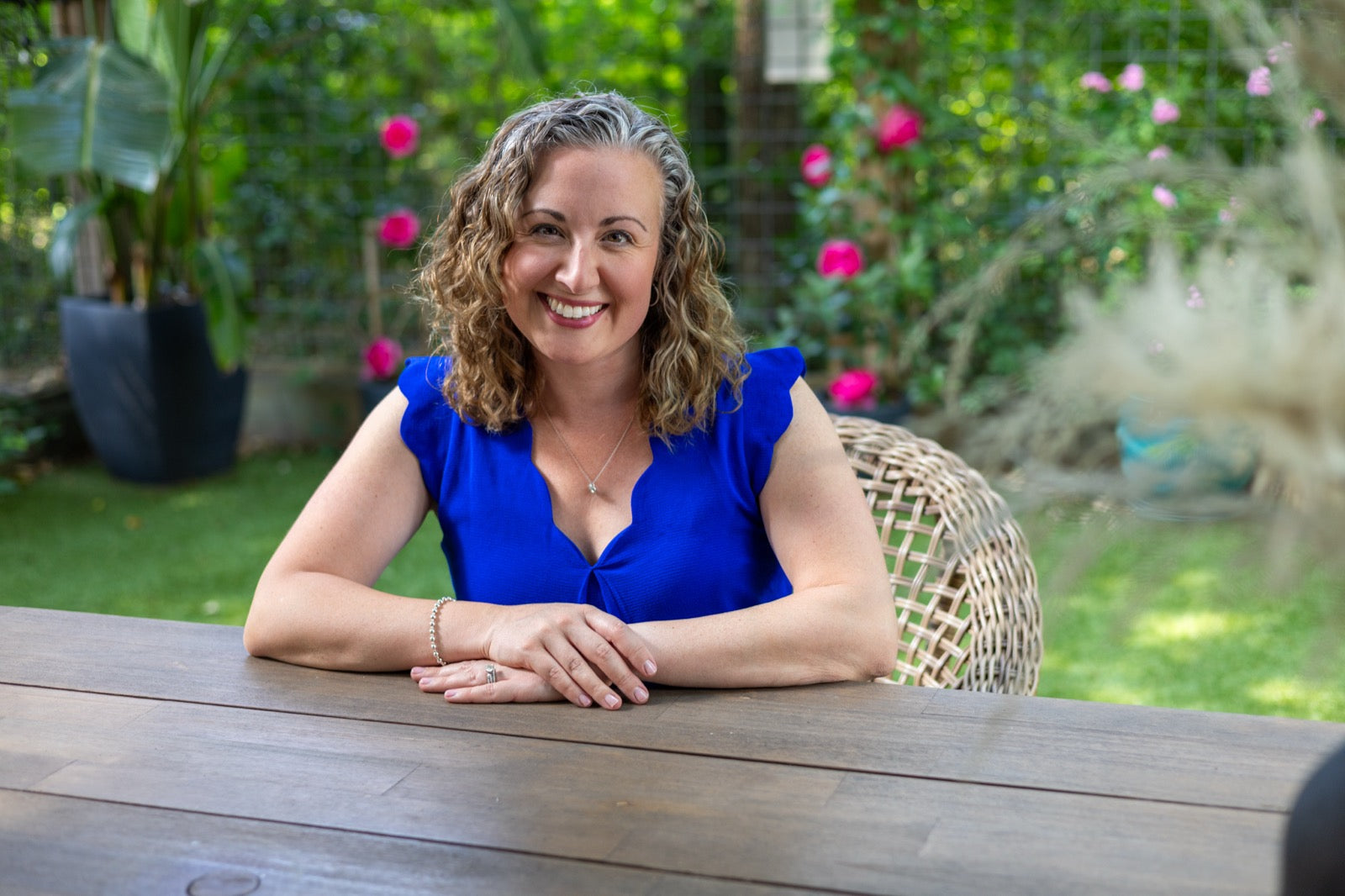 Coach Andrea Burke at an outdoor table in her garden